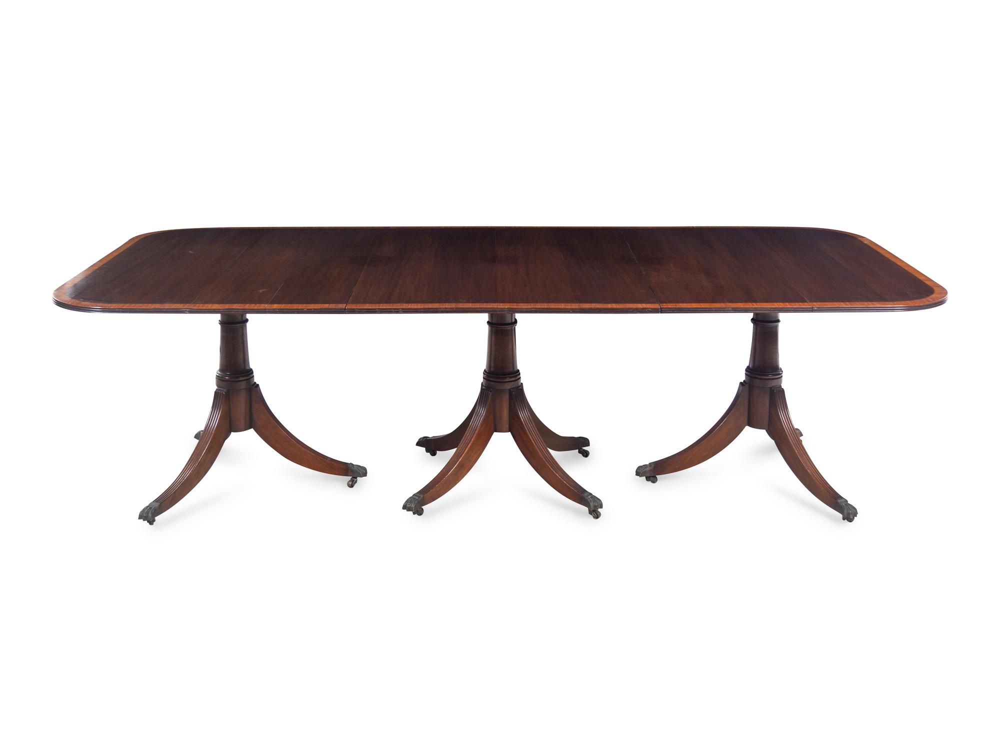A Regency Style Satinwood Banded Mahogany Triple-Pedestal Dining Table