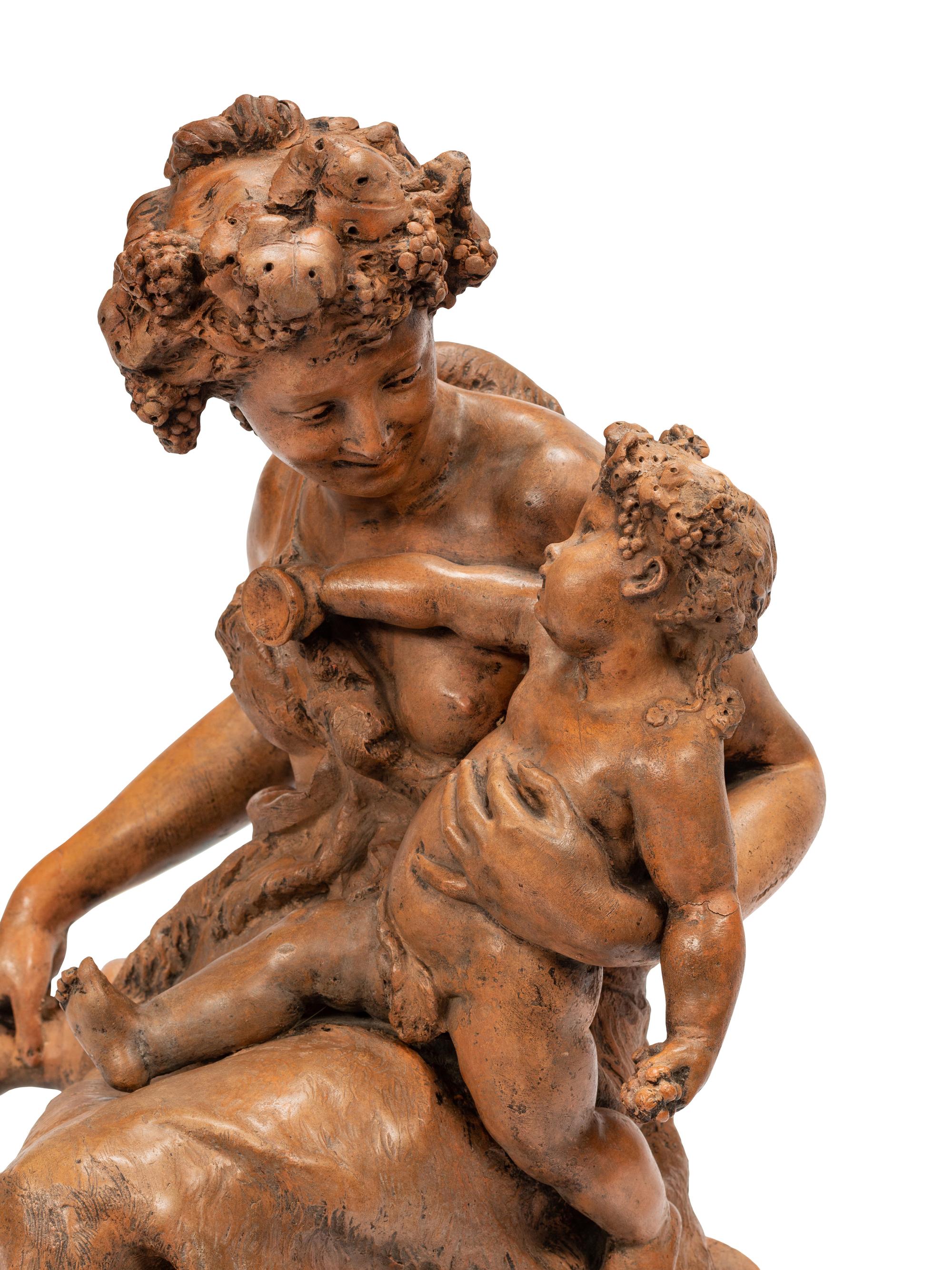 A Continental Terra Cotta Figural Group on a Faux Marble Base
