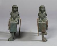 A Pair of Cast Iron Chenets, Height 11 3/4 inches.