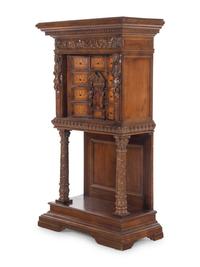 A Renaissance Revival Carved Walnut and Marquetry Collector's Cabinet
