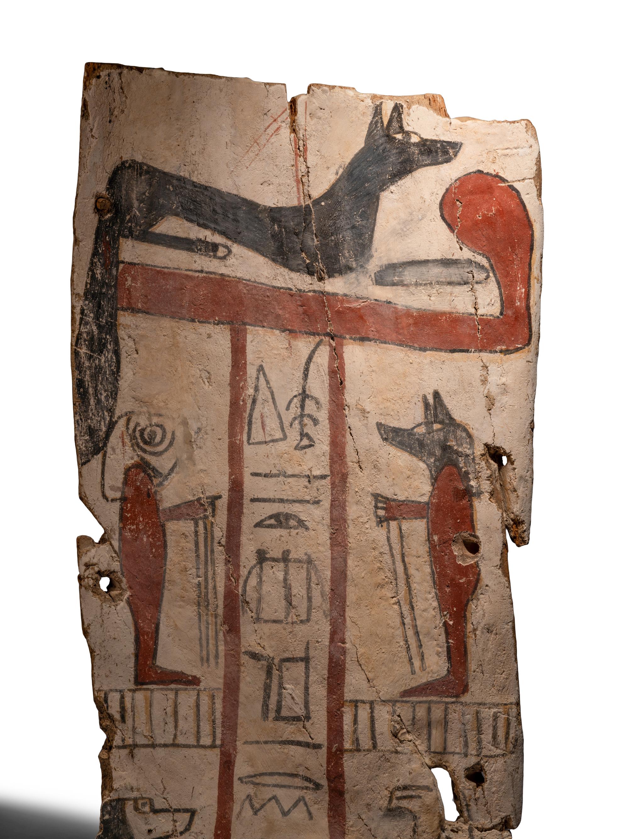 An Egyptian Painted Wood Sarcophagus Panel with Anubis