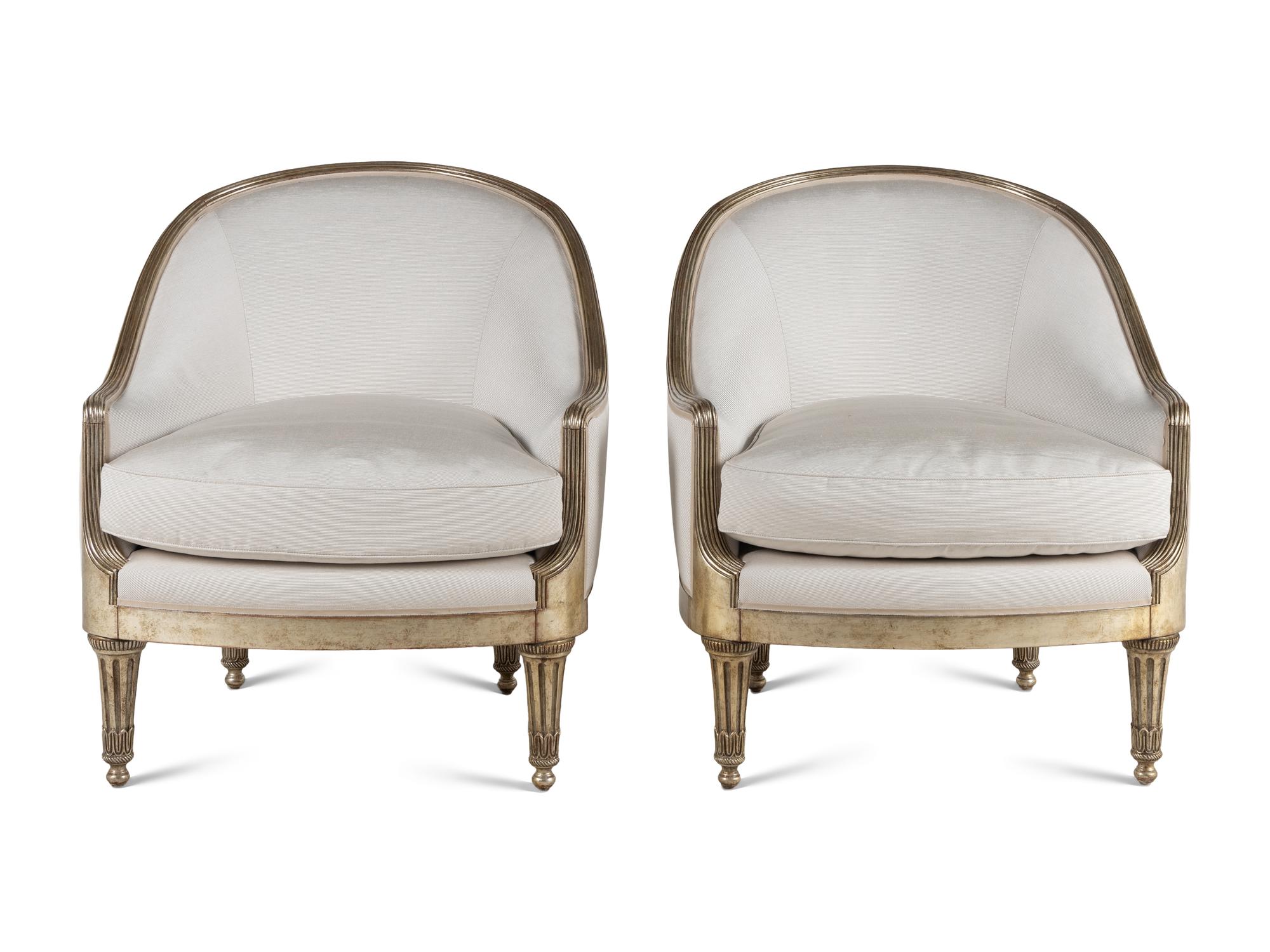 A Pair of Ebanista Silvered Wood Bergeres
