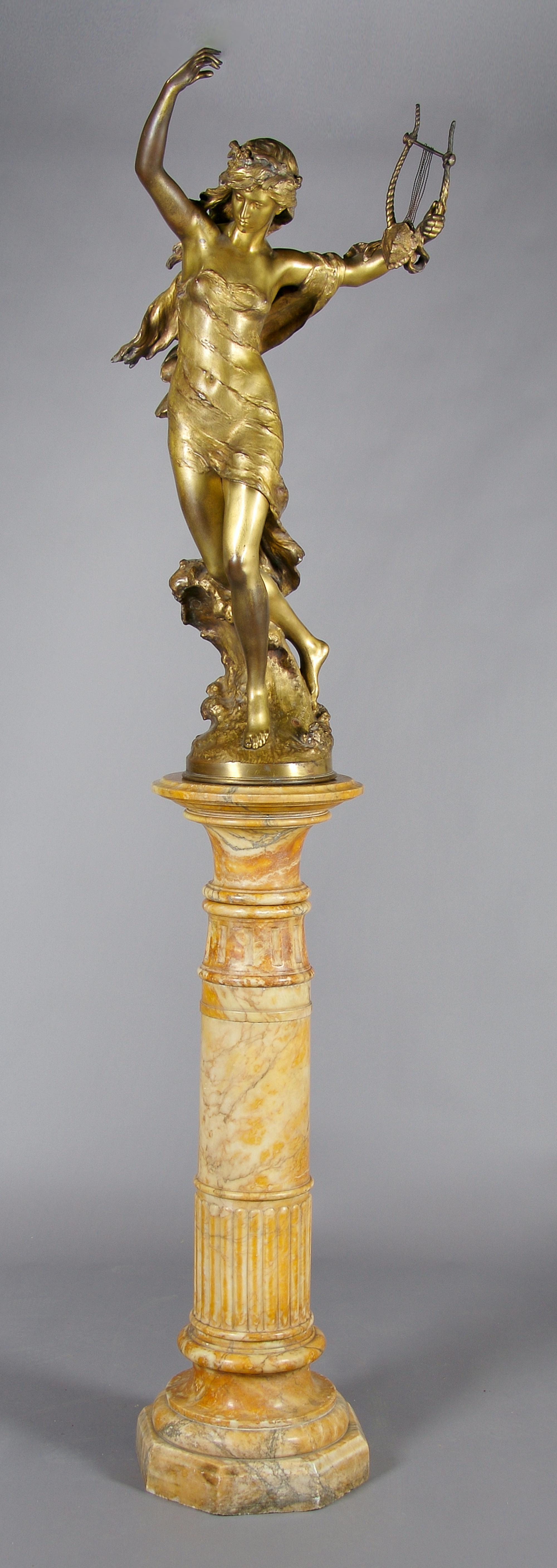 A French Gilt Bronze Figure of Sappho, Mathurin Moreau, Height of figure 44 inches, height of column 41 inches.