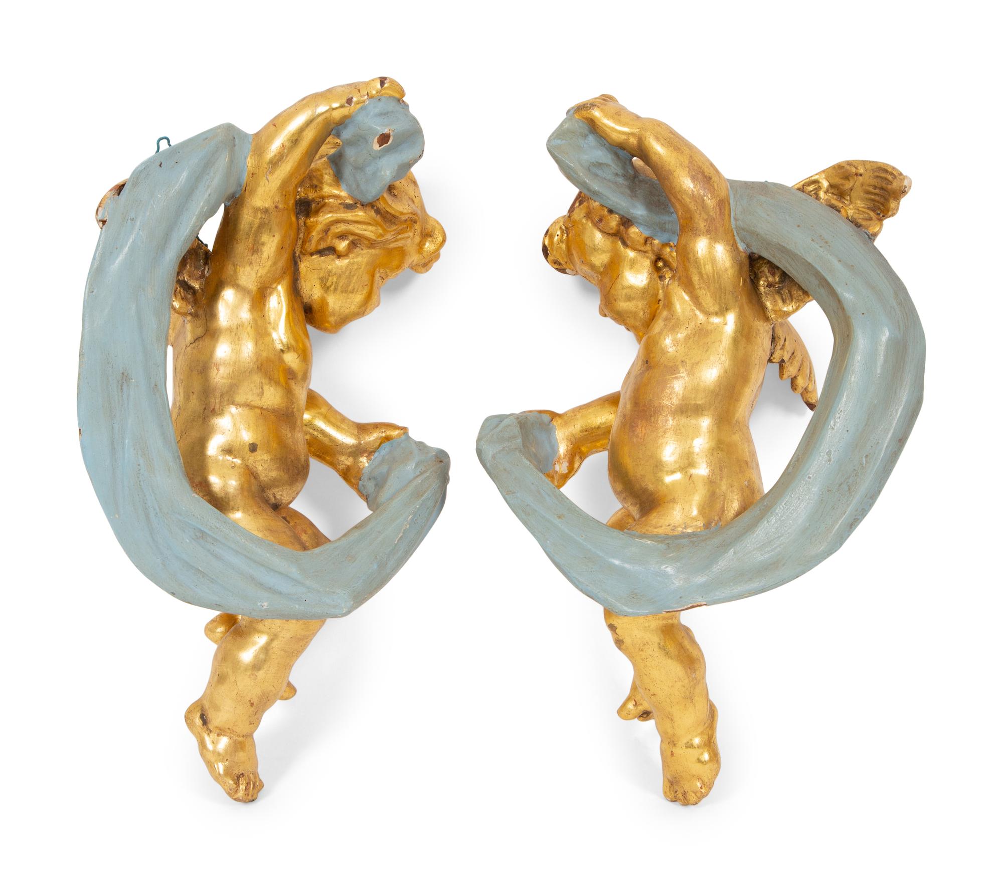A Pair of Italian Giltwood and Painted Putto-Form Wall Sconces