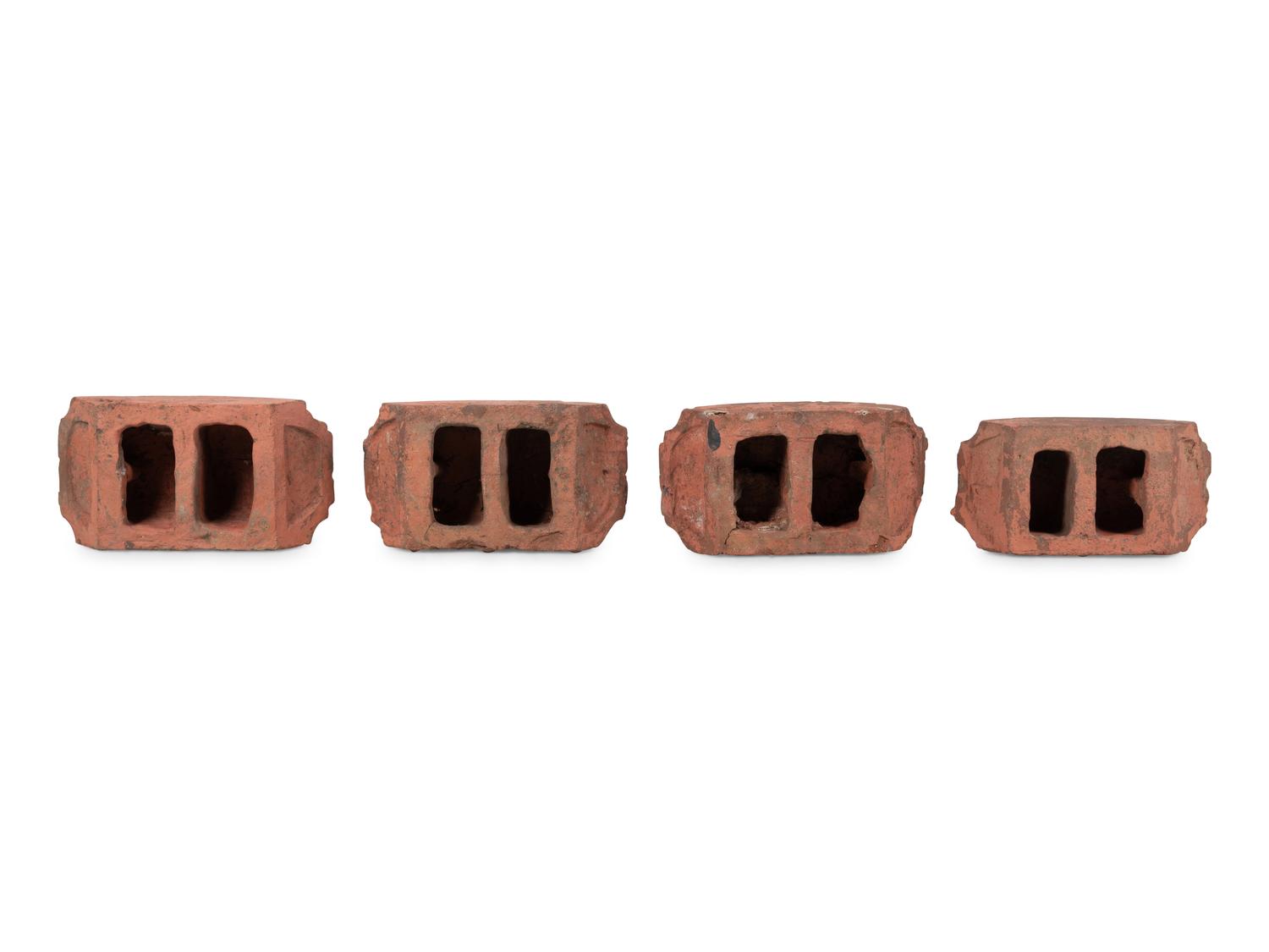 A Set of Four Continental Terra Cotta Ornaments
