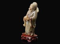 A Chinese carved celadon jade figure of a civil deity, possibly Caishen 青玉雕人物 可能為財神