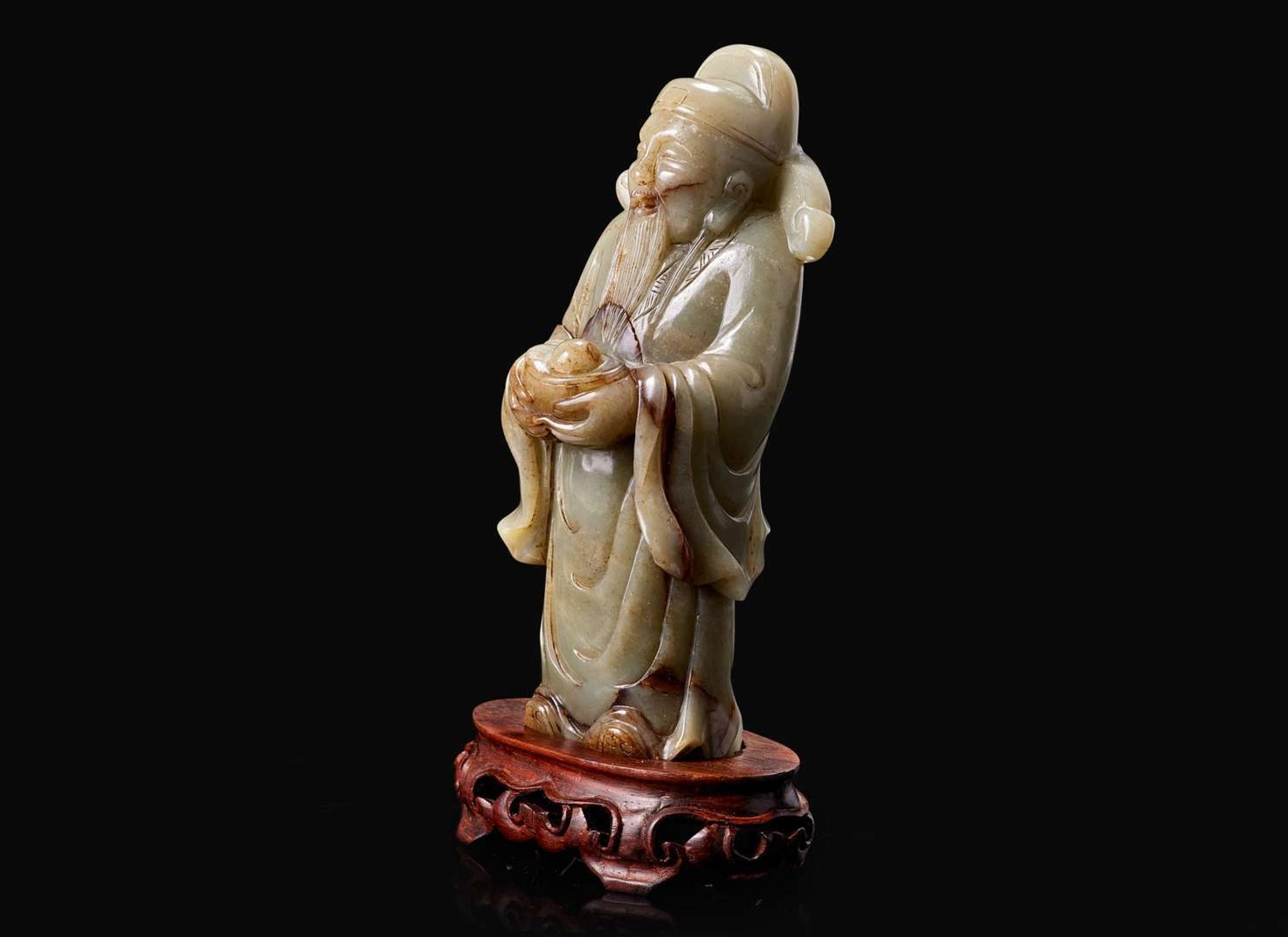 A Chinese carved celadon jade figure of a civil deity, possibly Caishen 青玉雕人物 可能為財神