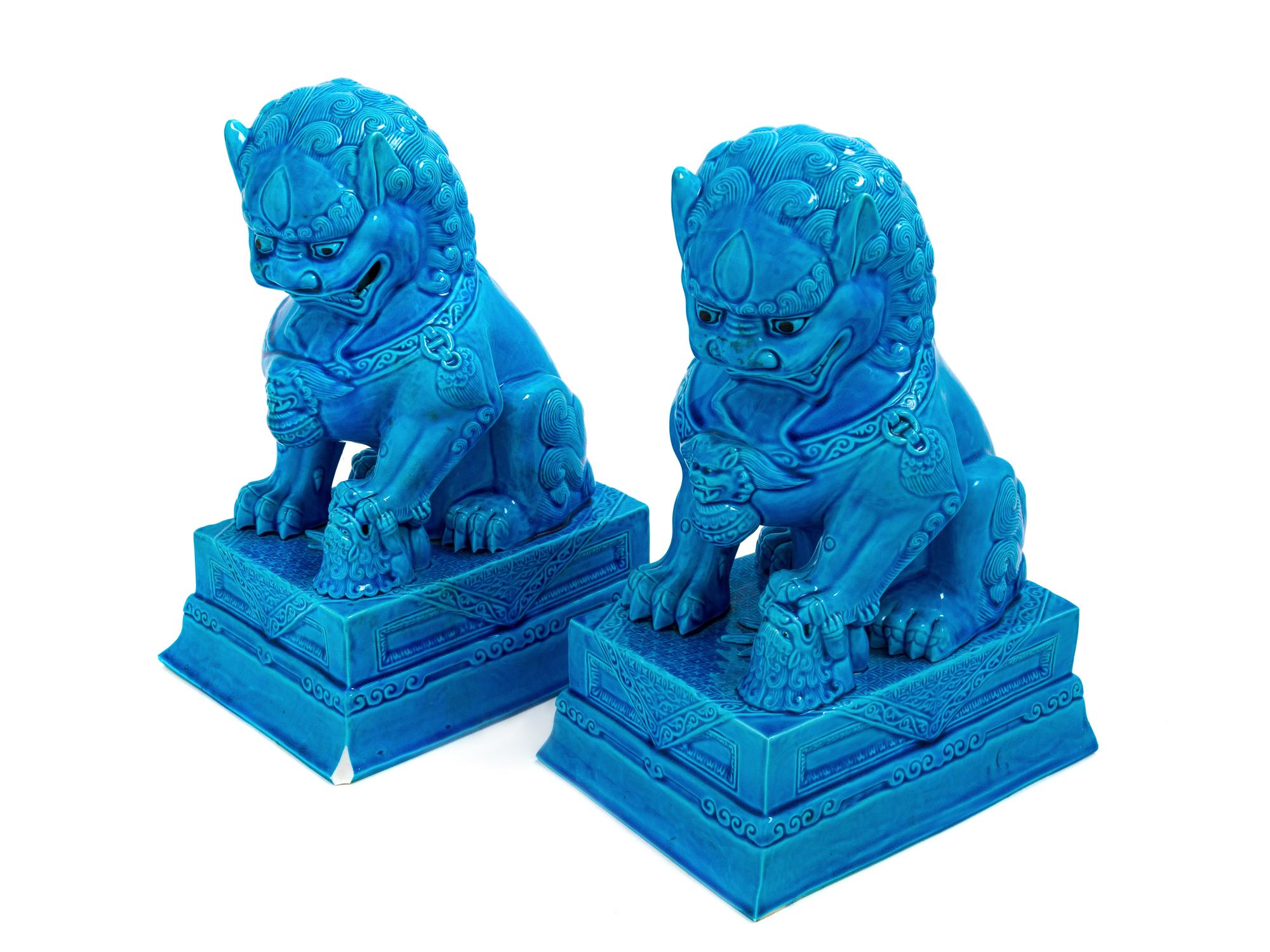 A Pair of Chinese Turquoise Glazed Porcelain Figures of Fu Lions
