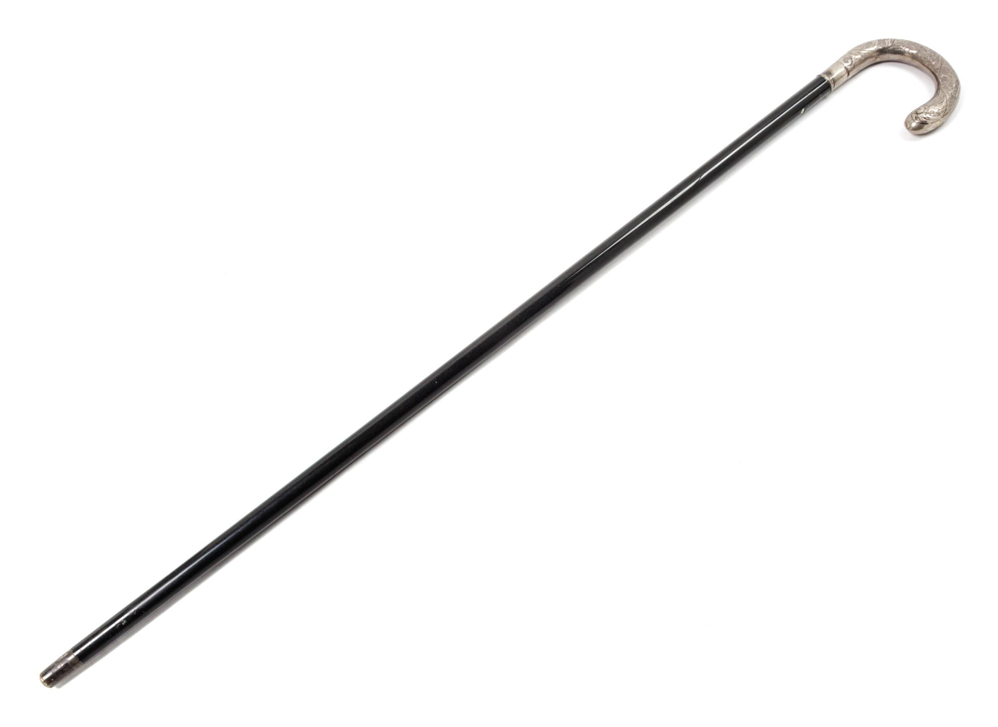 A Continental Silver Handled Ebonized Cane. Length 35 1/2 inches.