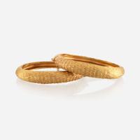 A pair of gold bracelets