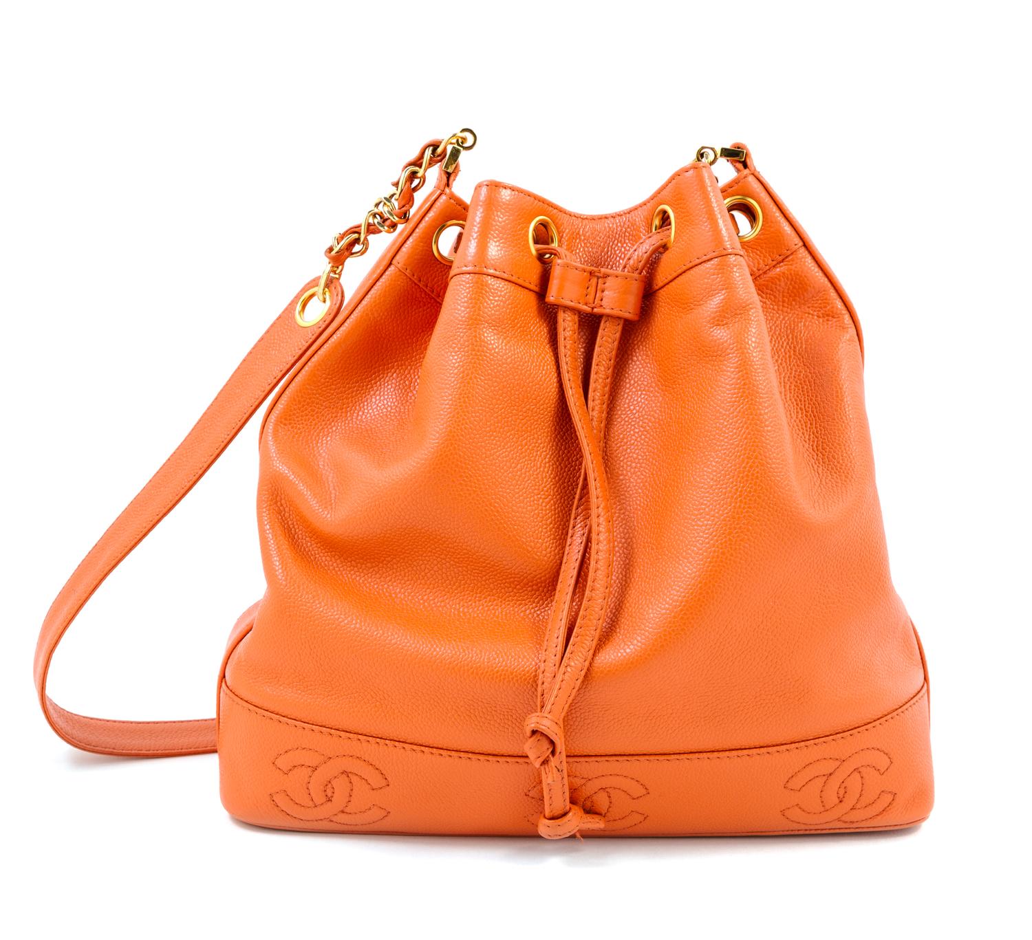 A Chanel Mandarin Caviar Leather Drawstring Bucket Bag, 14" x 12" x 4"; Strap drop: 19.75".