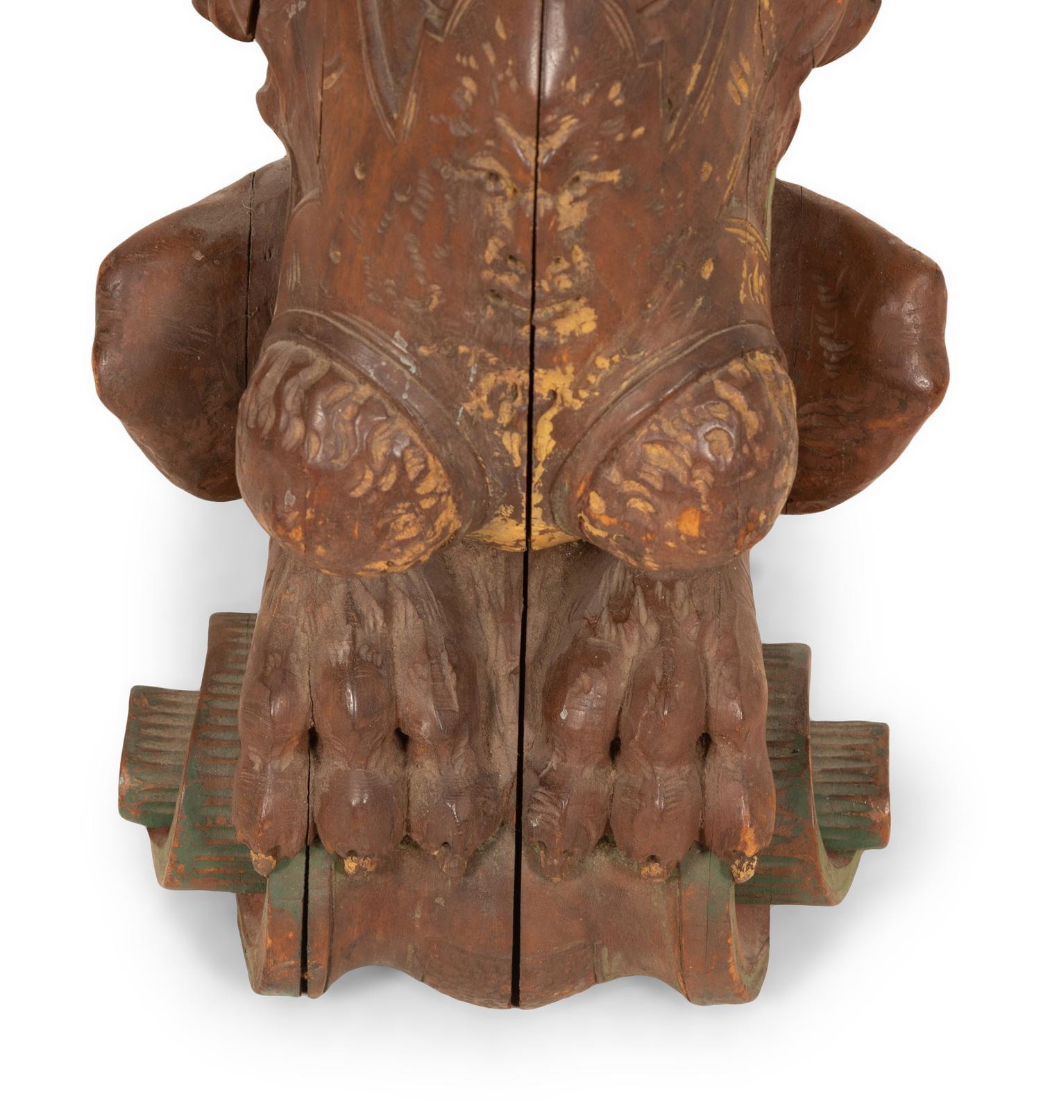 An Italian Carved and Polychromed Seated Dragon