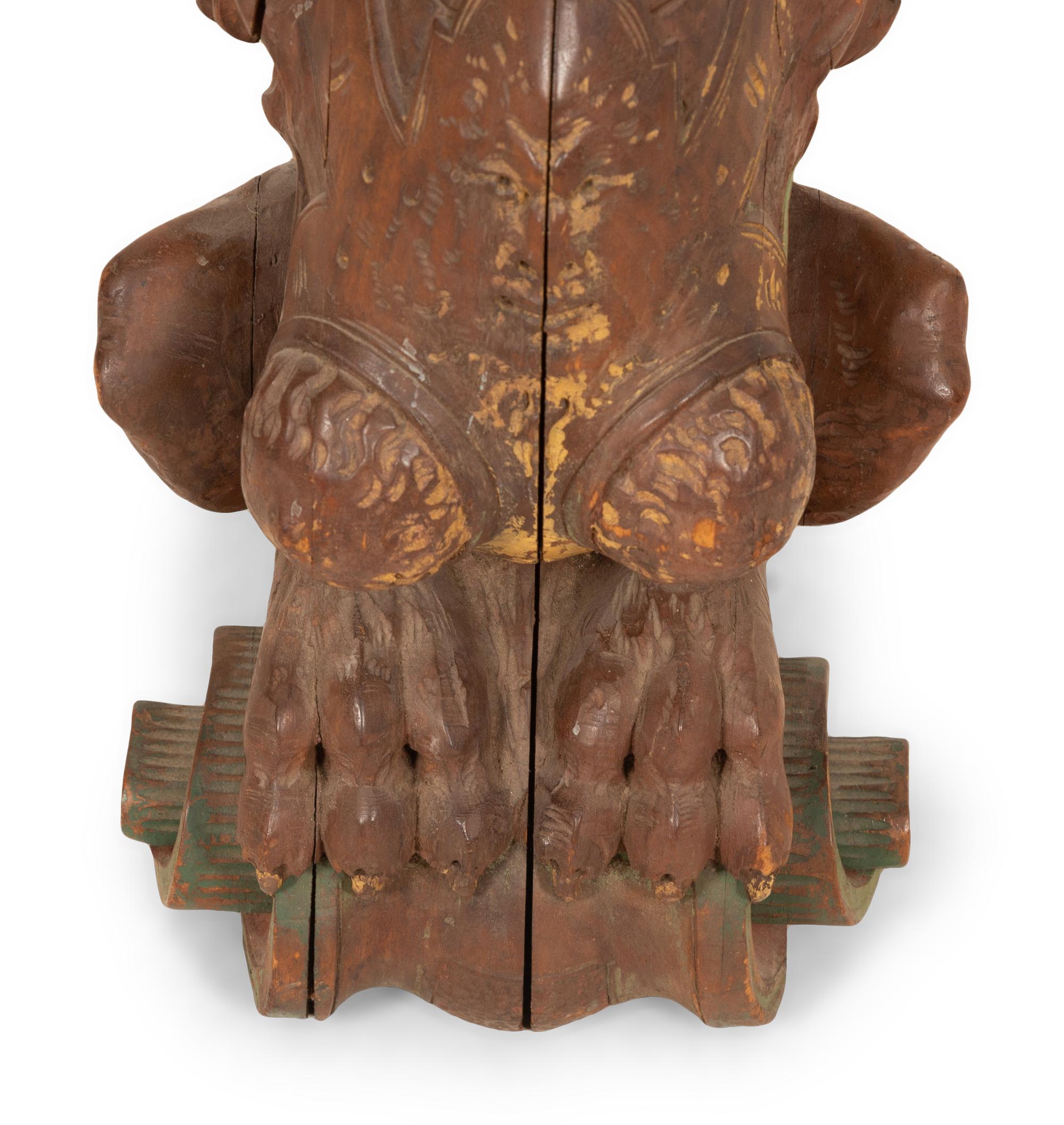 An Italian Carved and Polychromed Seated Dragon