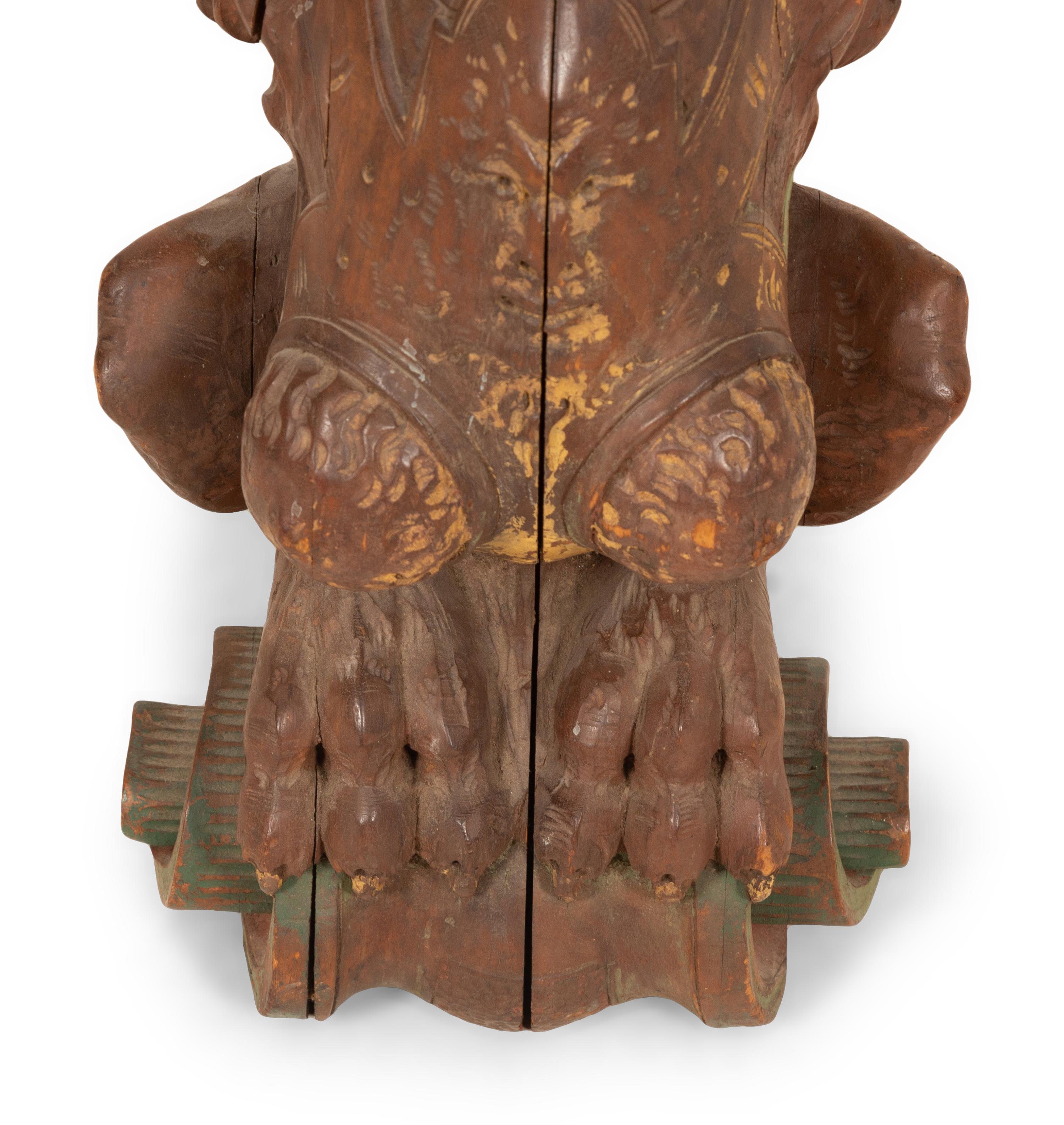 An Italian Carved and Polychromed Seated Dragon