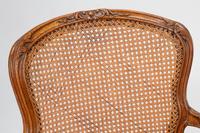 A Pair of Louis XV Beechwood Fauteuils with Cane and Leather Seat Cushions