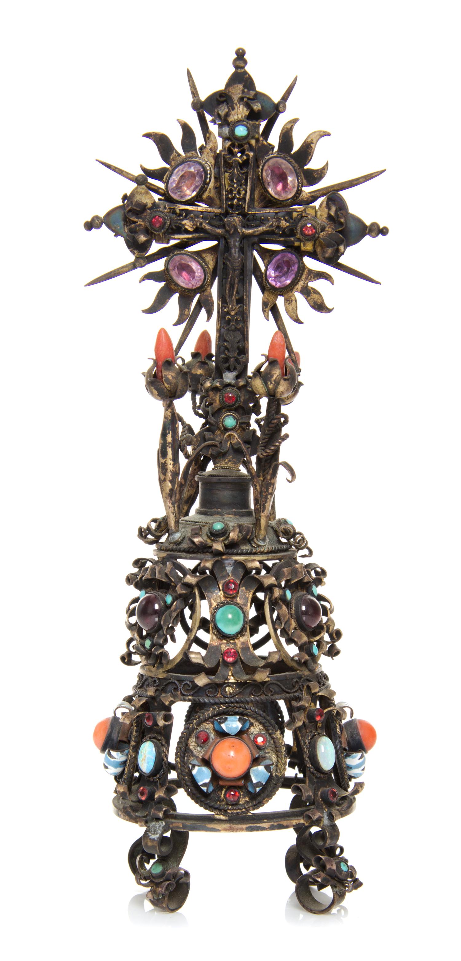 A Continental Silver-Gilt and Jewel Inset Cross, 19th Century, set on a tapering scrollwork base.
