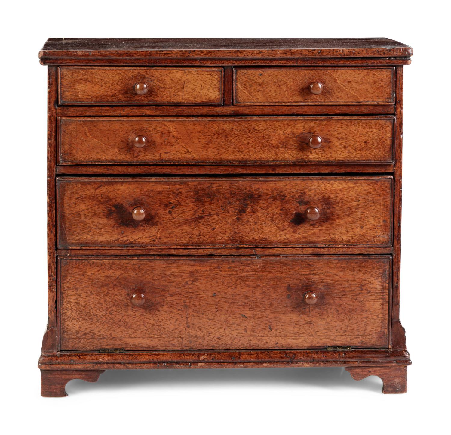 A Diminutive Walnut Chest of Drawers