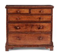A Diminutive Walnut Chest of Drawers