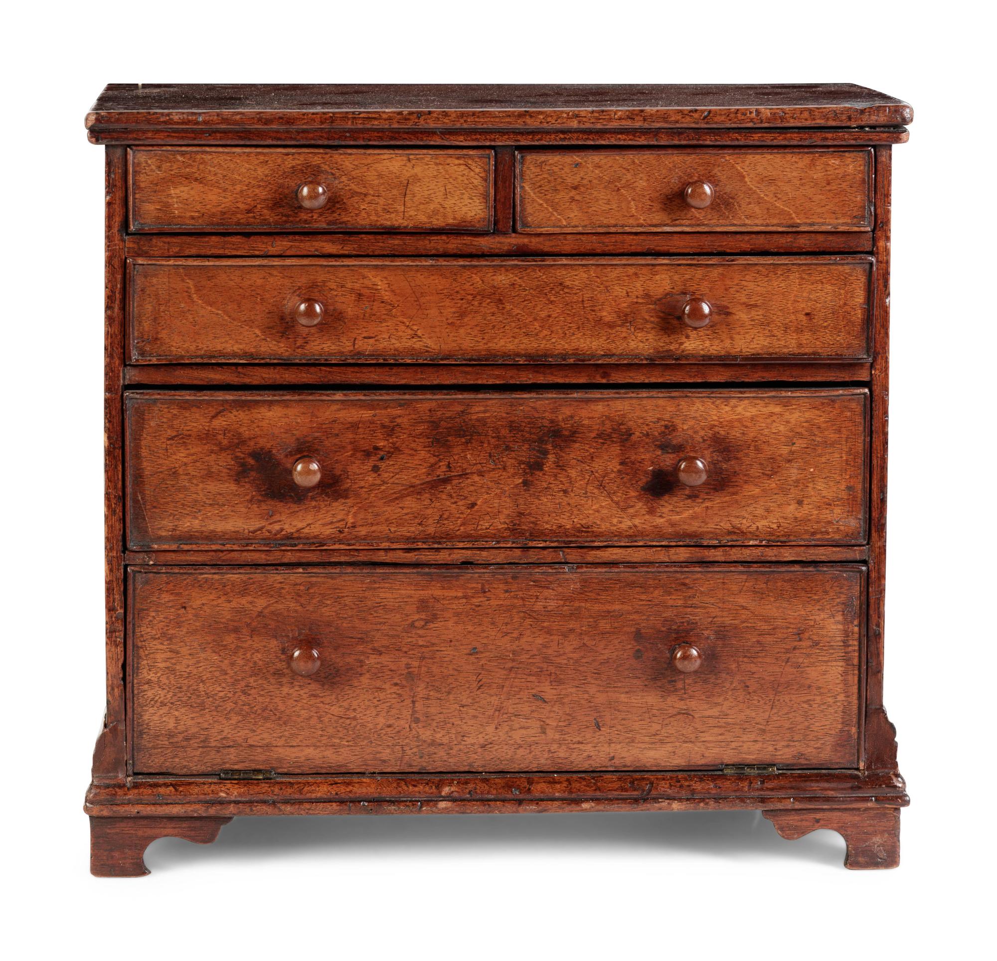 A Diminutive Walnut Chest of Drawers
