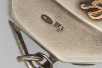 A Russian Silver Change Purse, Mark of Nikolai Antipov, Moscow, late 19th/early 20th century, with applied monograms and charms, having