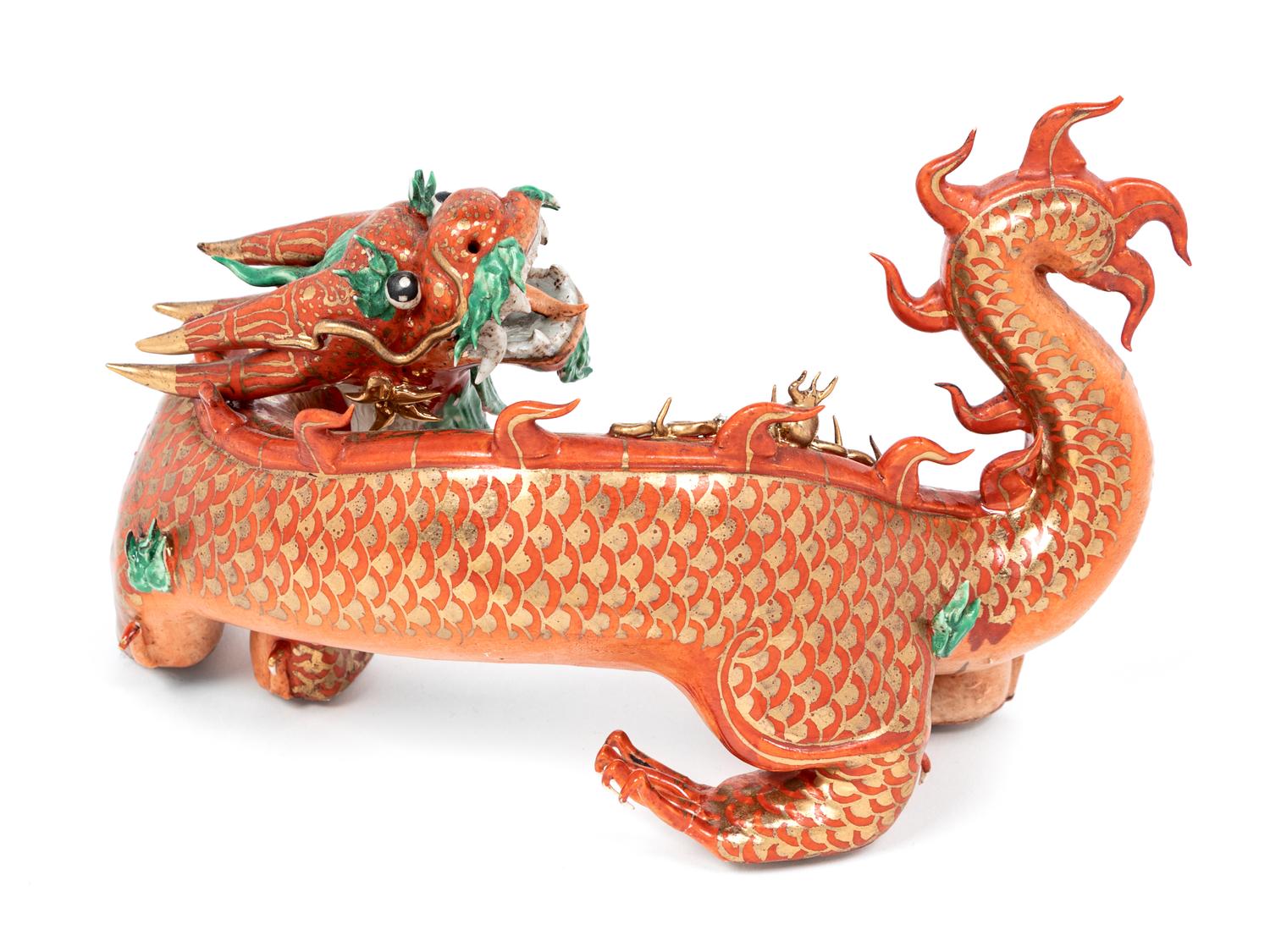 A Chinese Coral Red Ground Gilt and Green Enameled Porcelain Figure of Dragon