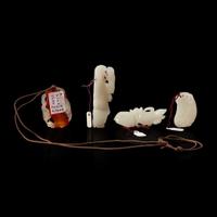 A group of three Chinese white jade carvings and a carnelian pendant