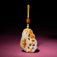 A Chinese Russet and White Jade Reticulated 'Lotus' Pendant, 18th/19th Century — 清中期 白玉帶皮鏤雕蓮紋佩
