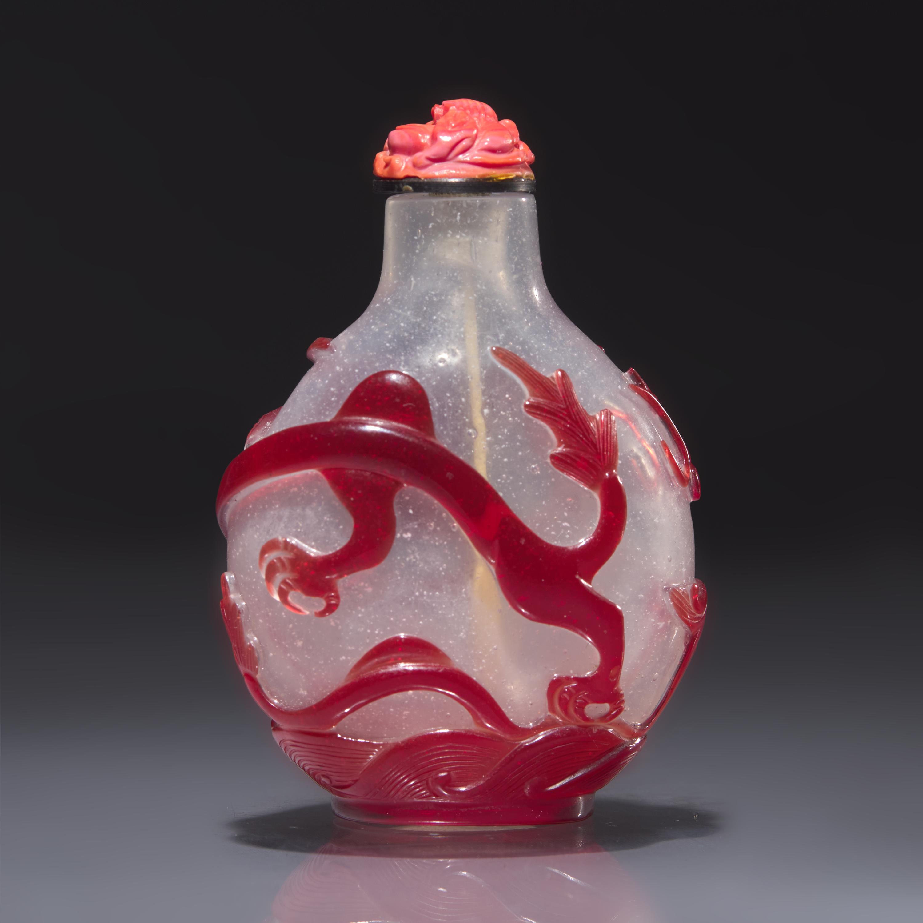 A Chinese Ruby Overlay Glass "Dragon" Snuff Bottle, Qing Dynasty, 18th Century — 清中期 雪霏地套寶石紅料龍戲珠鼻煙壺