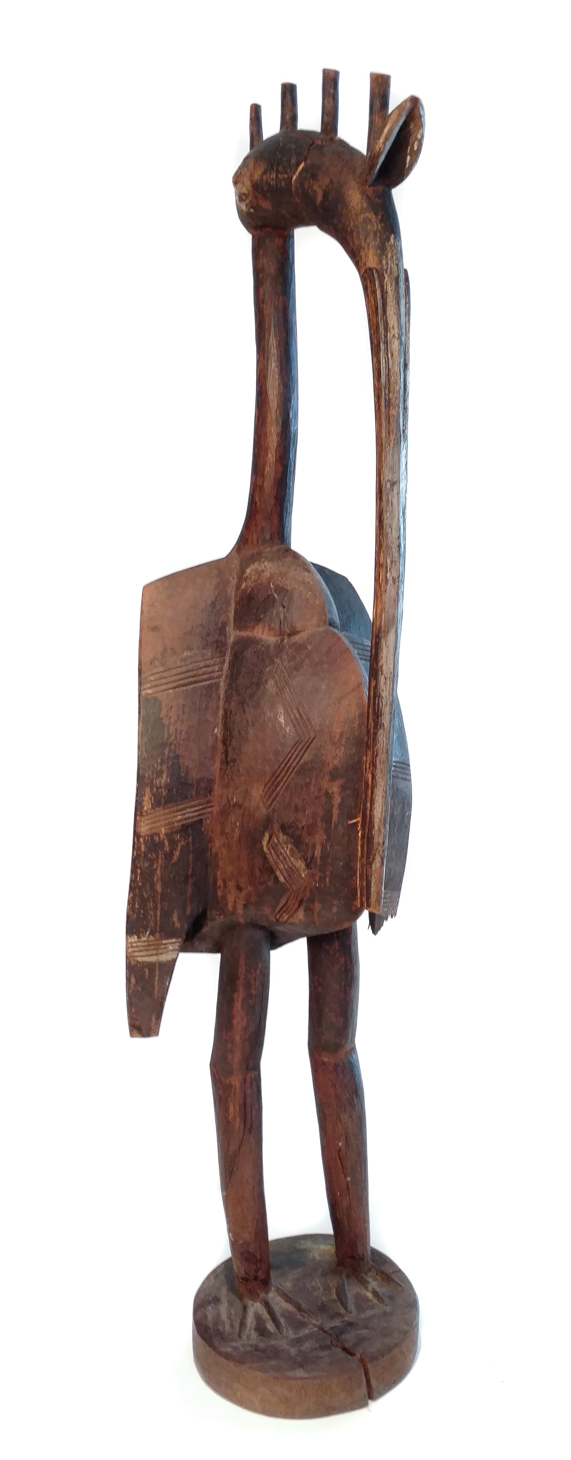 A Carved African Model of a Bird Height 44 inches.