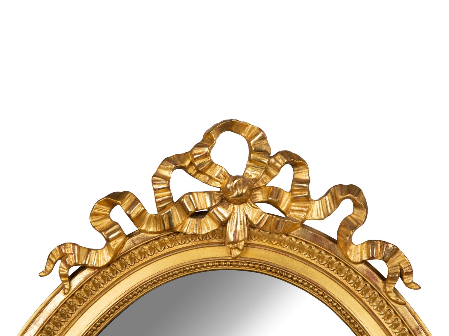 A Louis XV Style Giltwood Framed Oval Mirror — 19TH CENTURY