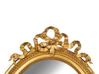 A Louis XV Style Giltwood Framed Oval Mirror — 19TH CENTURY