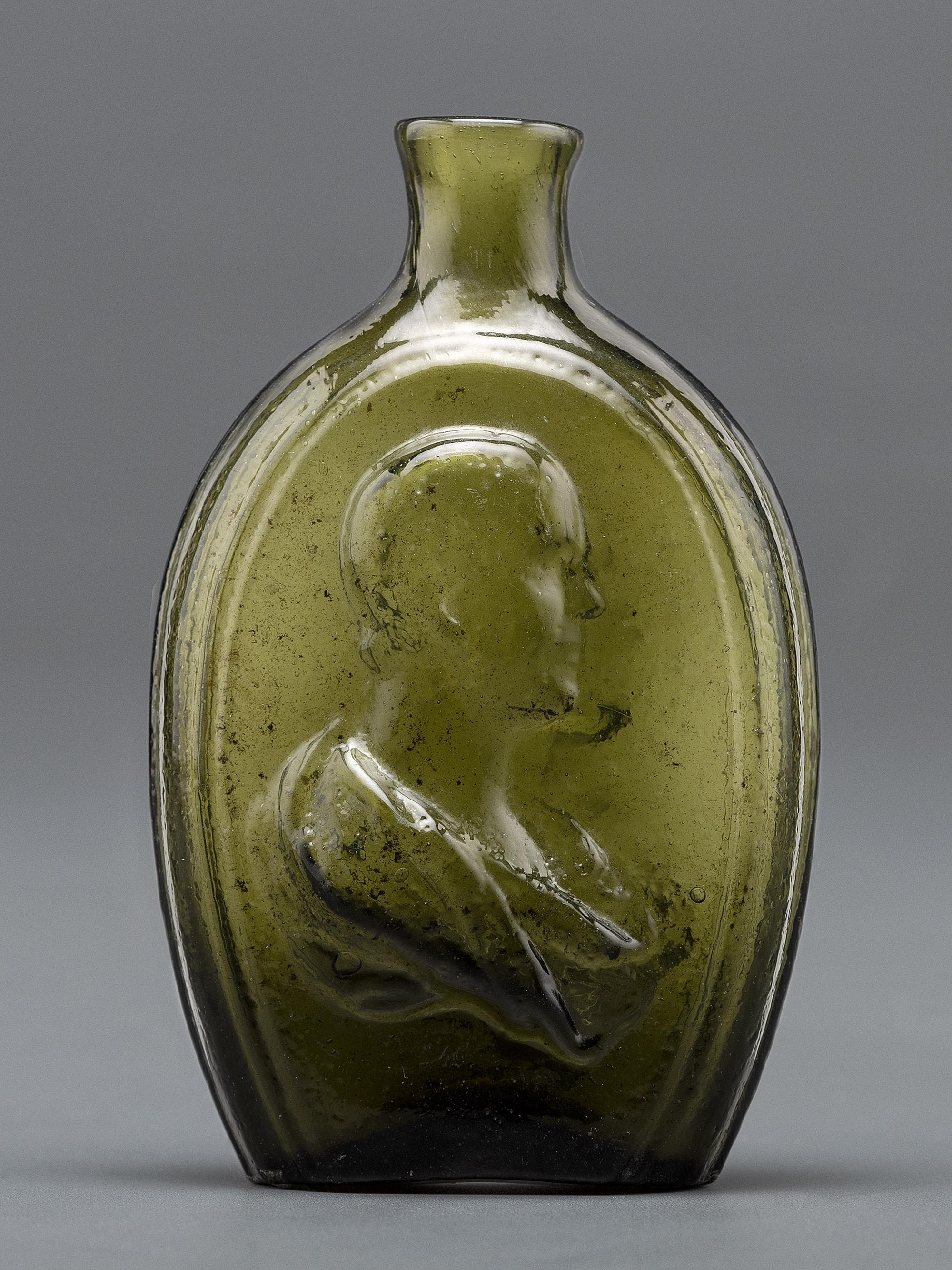 An Olive Green Glass Portrait Bust Flask