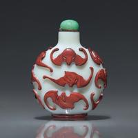 A Chinese Carved Red-Overlaid White Glass "Bats" Snuff Bottle, Qing Dynasty, Circa 1780-1850 — 1780-1850年 涅白地套紅料蝙蝠紋鼻煙壺