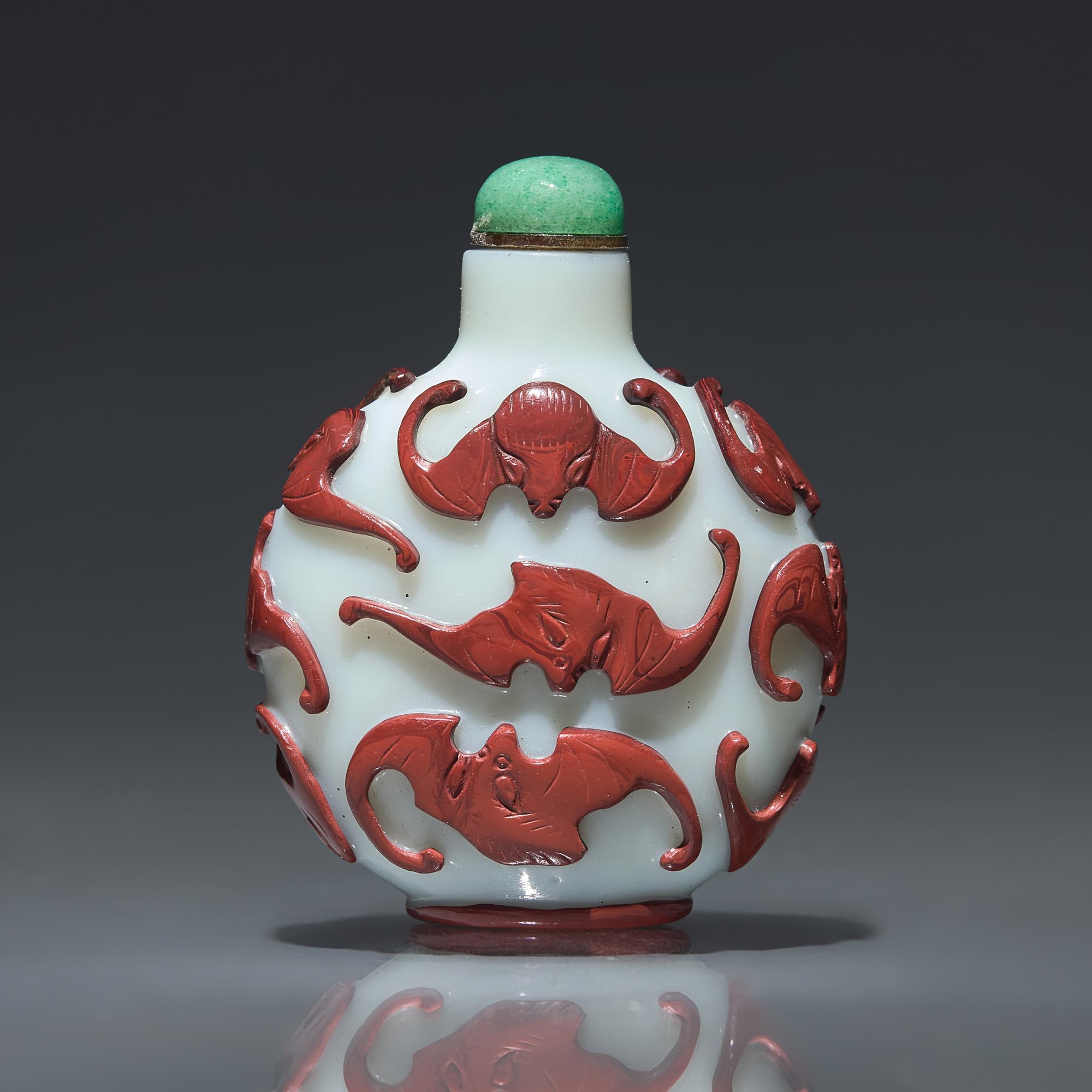 A Chinese Carved Red-Overlaid White Glass "Bats" Snuff Bottle, Qing Dynasty, Circa 1780-1850 — 1780-1850年 涅白地套紅料蝙蝠紋鼻煙壺