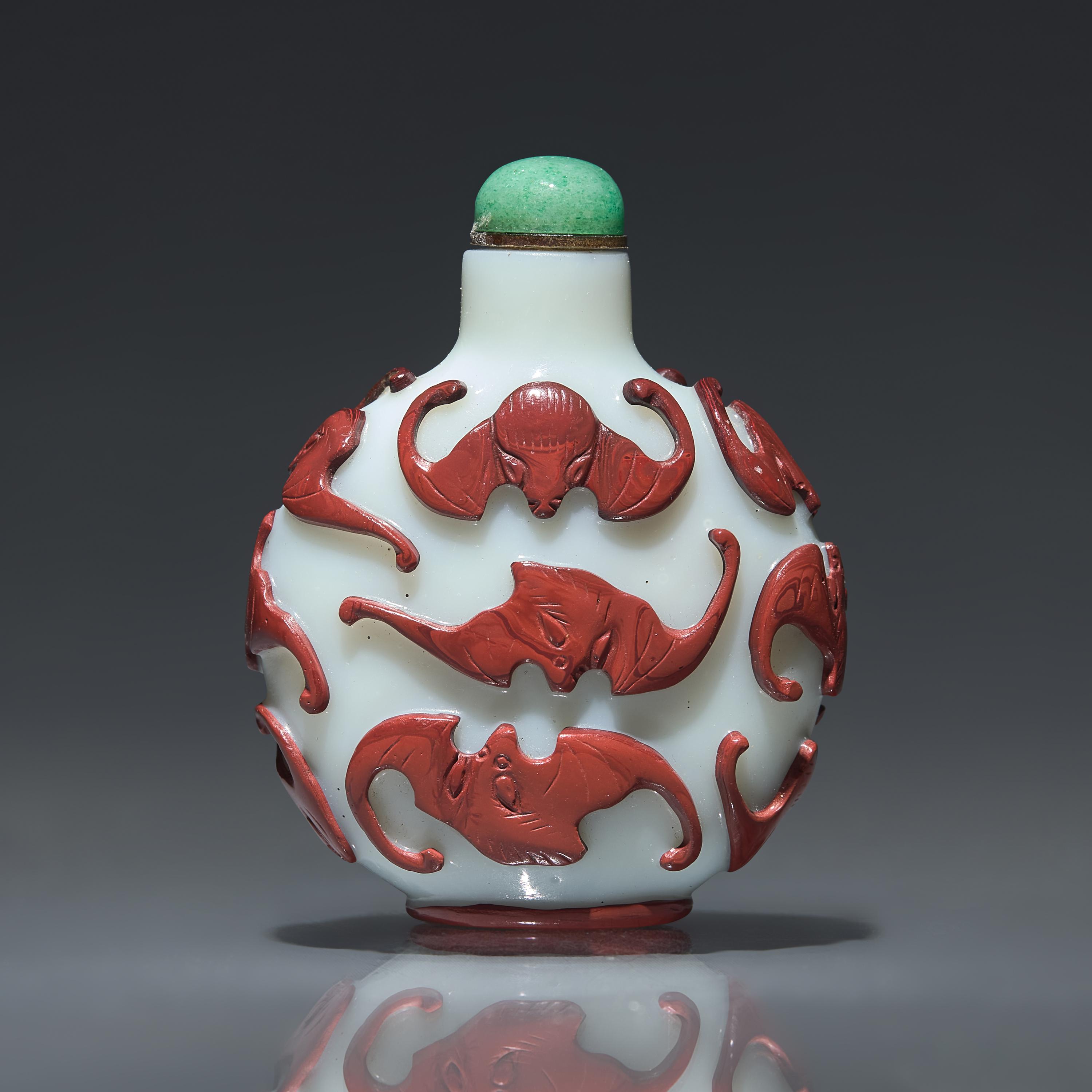 A Chinese Carved Red-Overlaid White Glass "Bats" Snuff Bottle, Qing Dynasty, Circa 1780-1850 — 1780-1850年 涅白地套紅料蝙蝠紋鼻煙壺