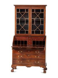 A Chippendale Mahogany and Cherrywood Serpentine Claw-and-Ball Foot Desk-and-Bookcase