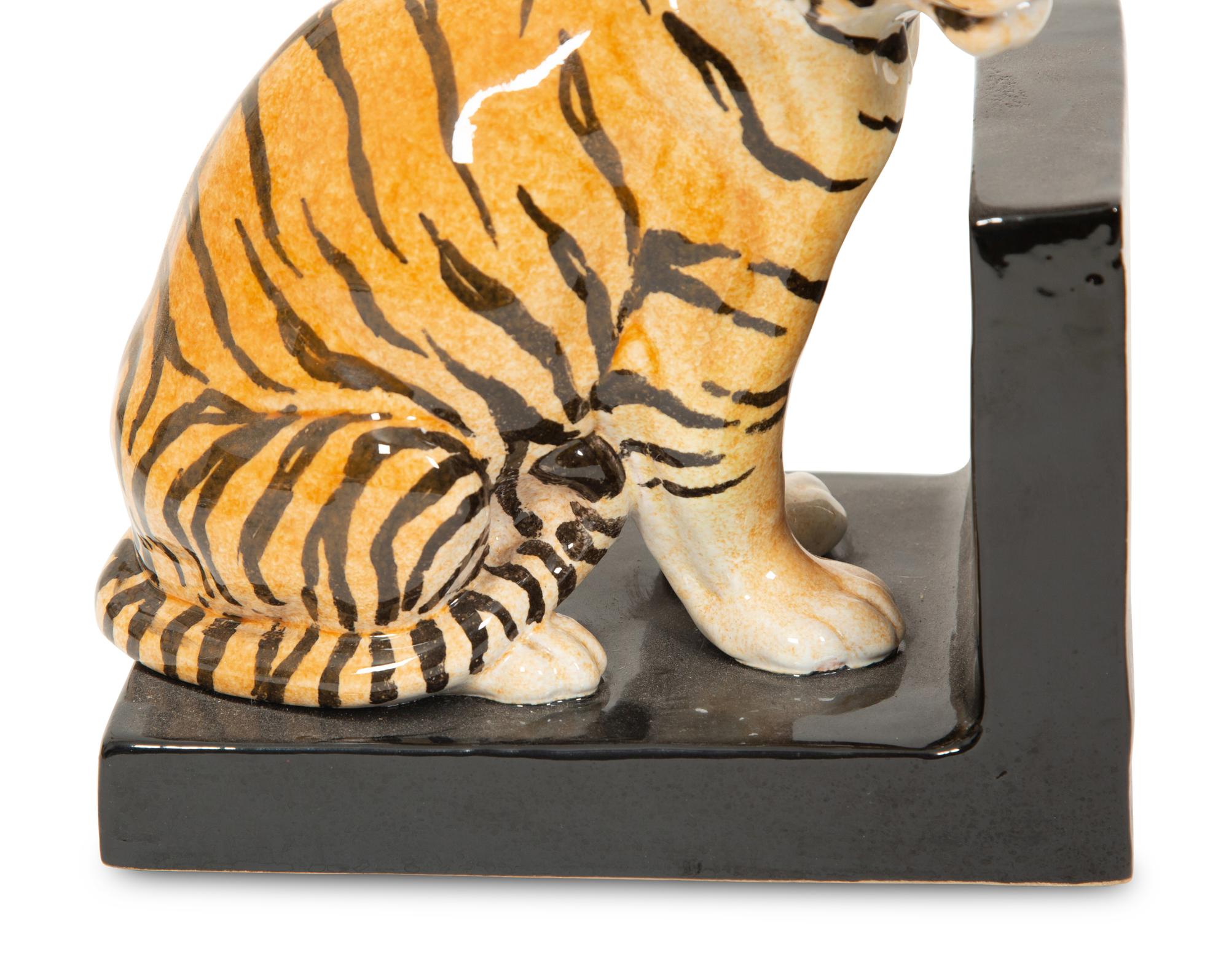 A Pair of Italian Glazed Terracotta Tiger Bookends and a Glazed Ceramic Leopard Head Jardiniere