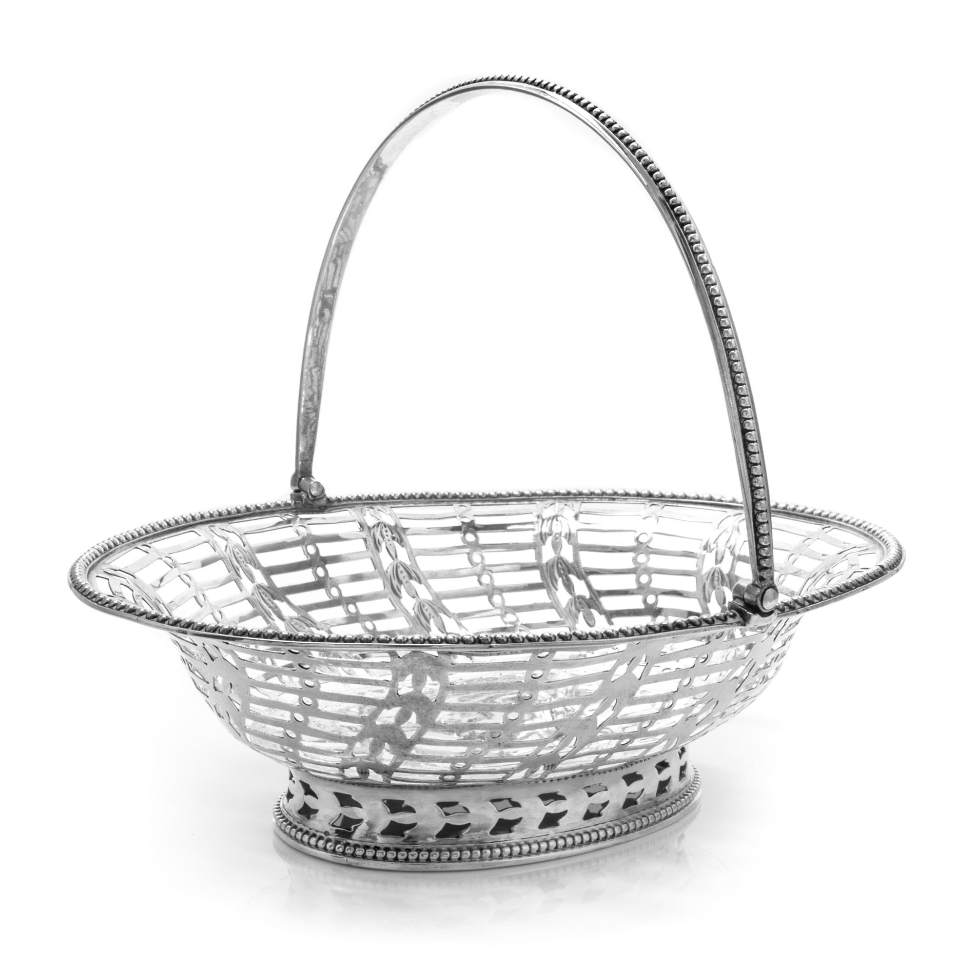 A George III Silver Reticulated Sweetmeat Basket, Hester Bateman, London, 1780, of oval form with a beaded edge and a swing handle, the