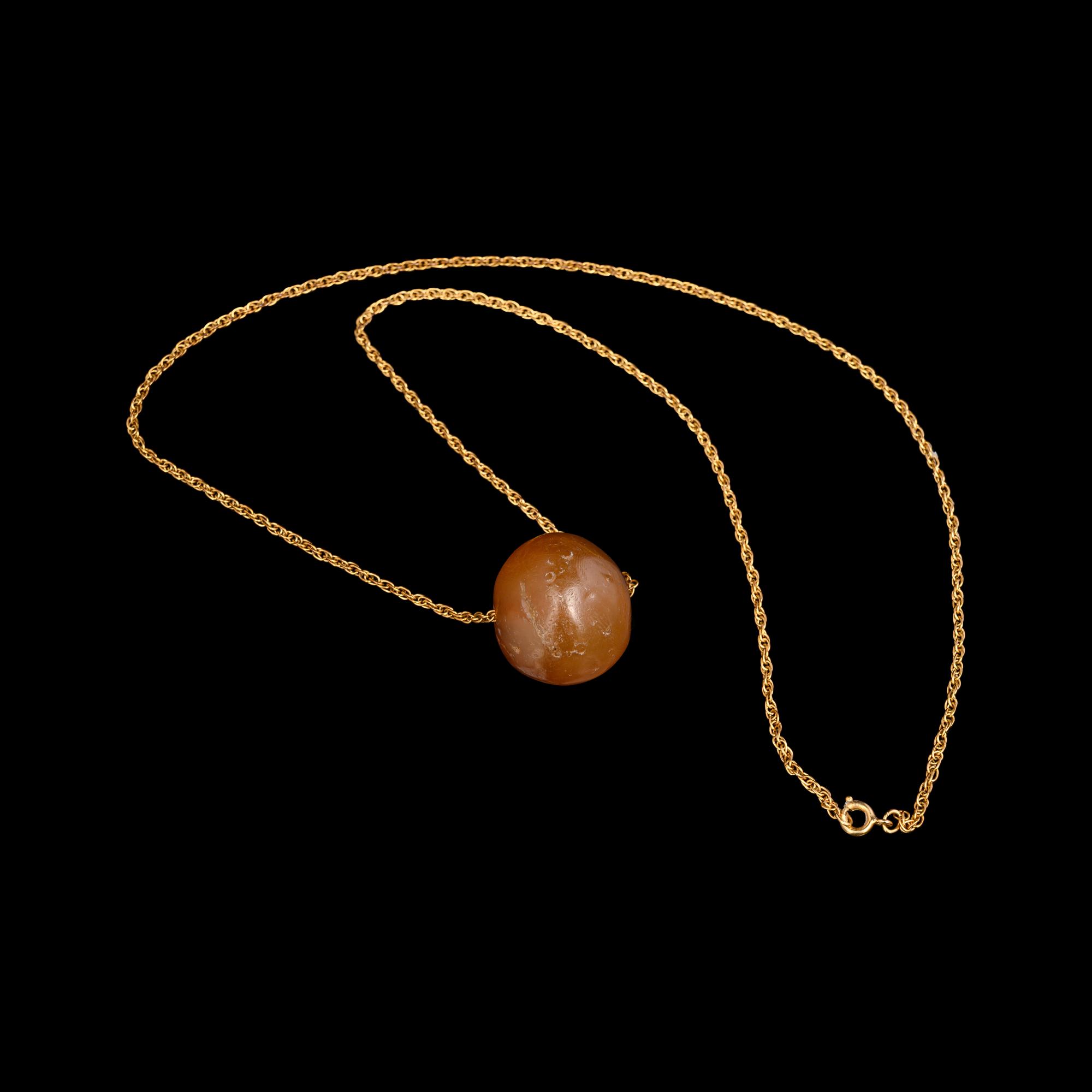 A Neo-Babylonian or Graeco-Persian Smokey Chalcedony Conoid Seal Necklace