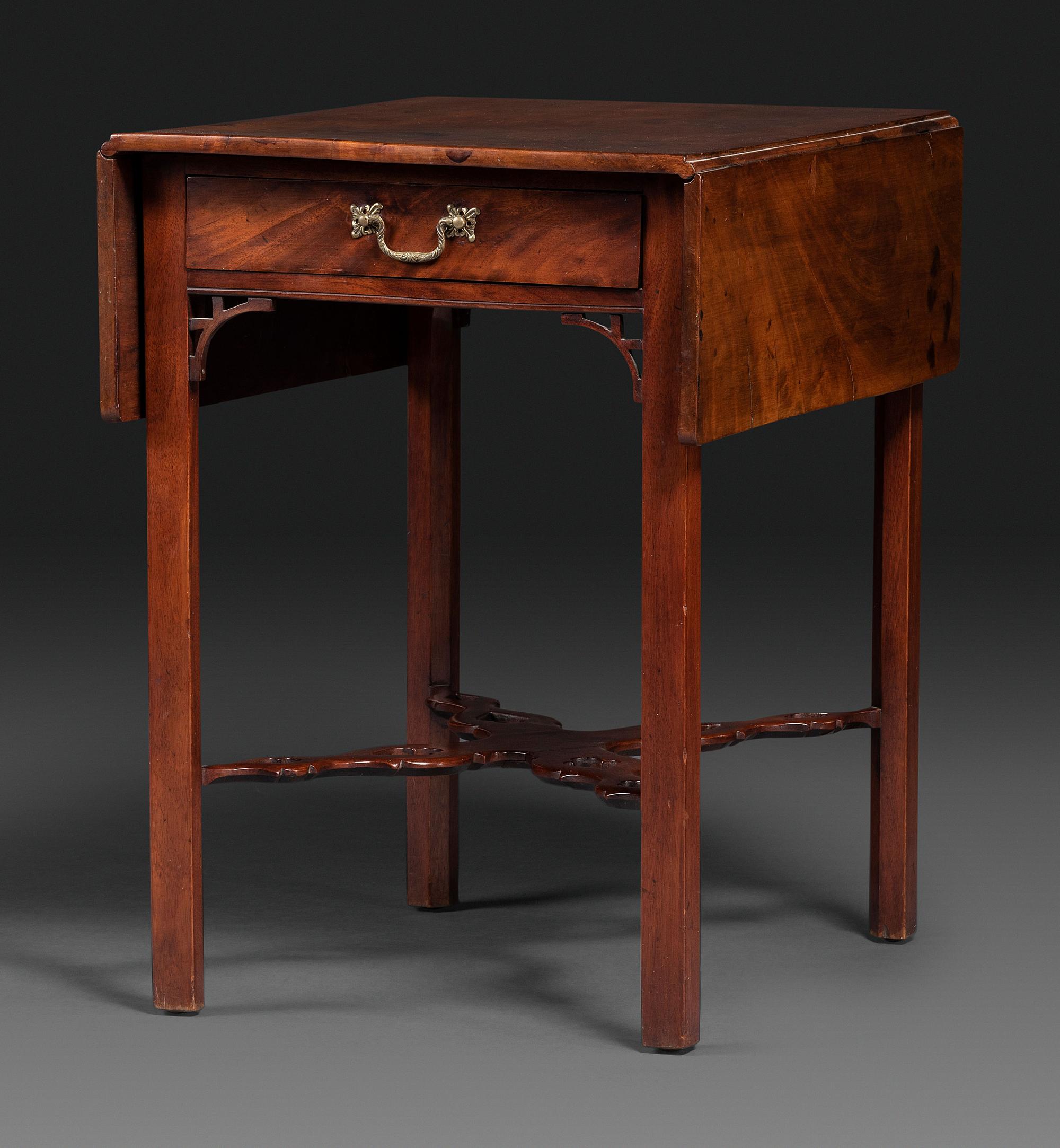 A Late Chippendale Carved and Figured Mahogany Stretcher-Base Pembroke Table