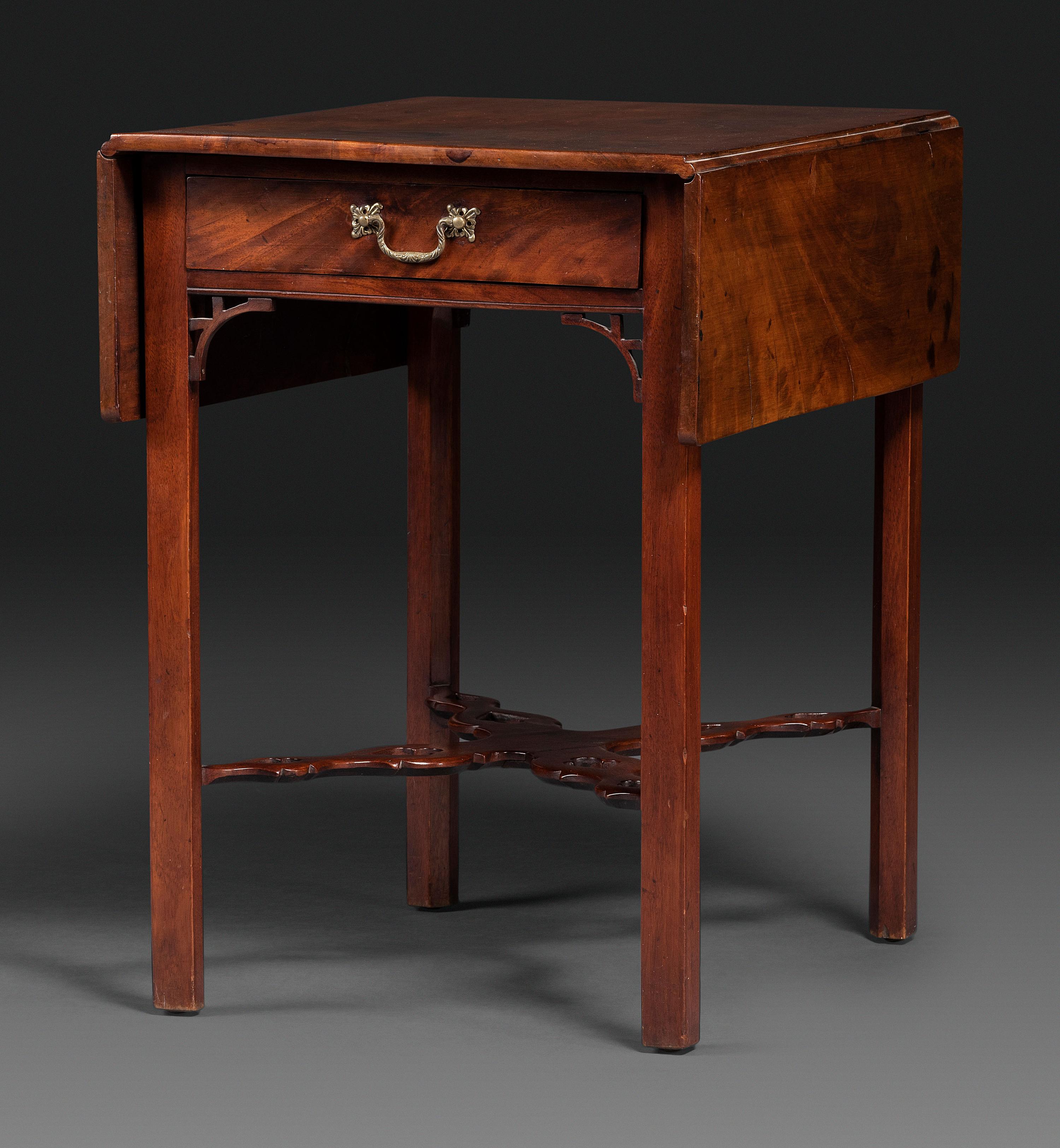 A Late Chippendale Carved and Figured Mahogany Stretcher-Base Pembroke Table