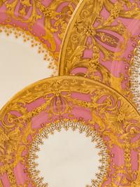 A Minton Parcel Gilt Porcelain Dinner Service by S.J. Russell