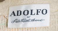 An Adolfo Cream Boucle Skirt Ensemble, No size. Handbag: 8'' x 6''; Strap drop: 10''.