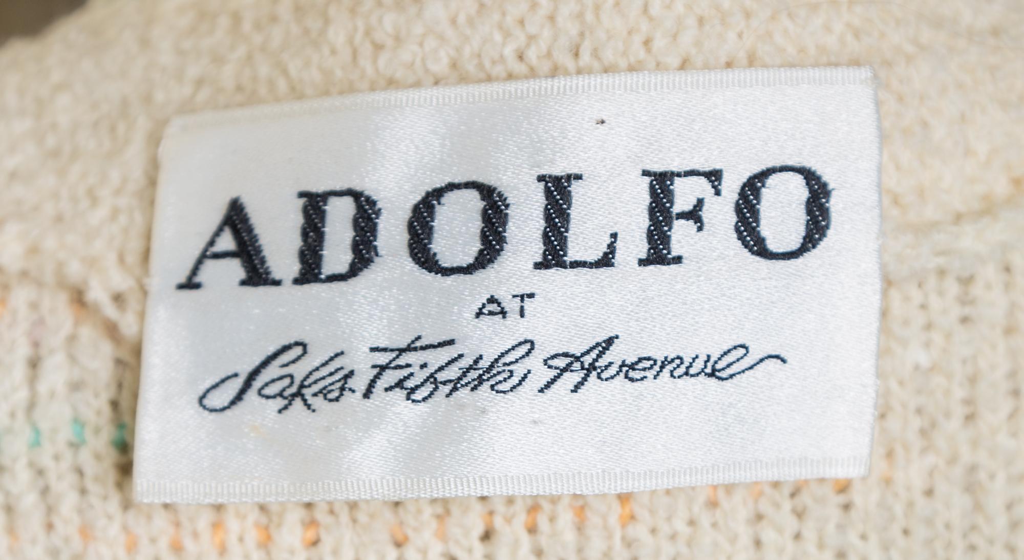An Adolfo Cream Boucle Skirt Ensemble, No size. Handbag: 8'' x 6''; Strap drop: 10''.