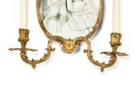 A Pair of Continental Plaster Relief Medallion and Gilt Bronze Two-Light Sconces