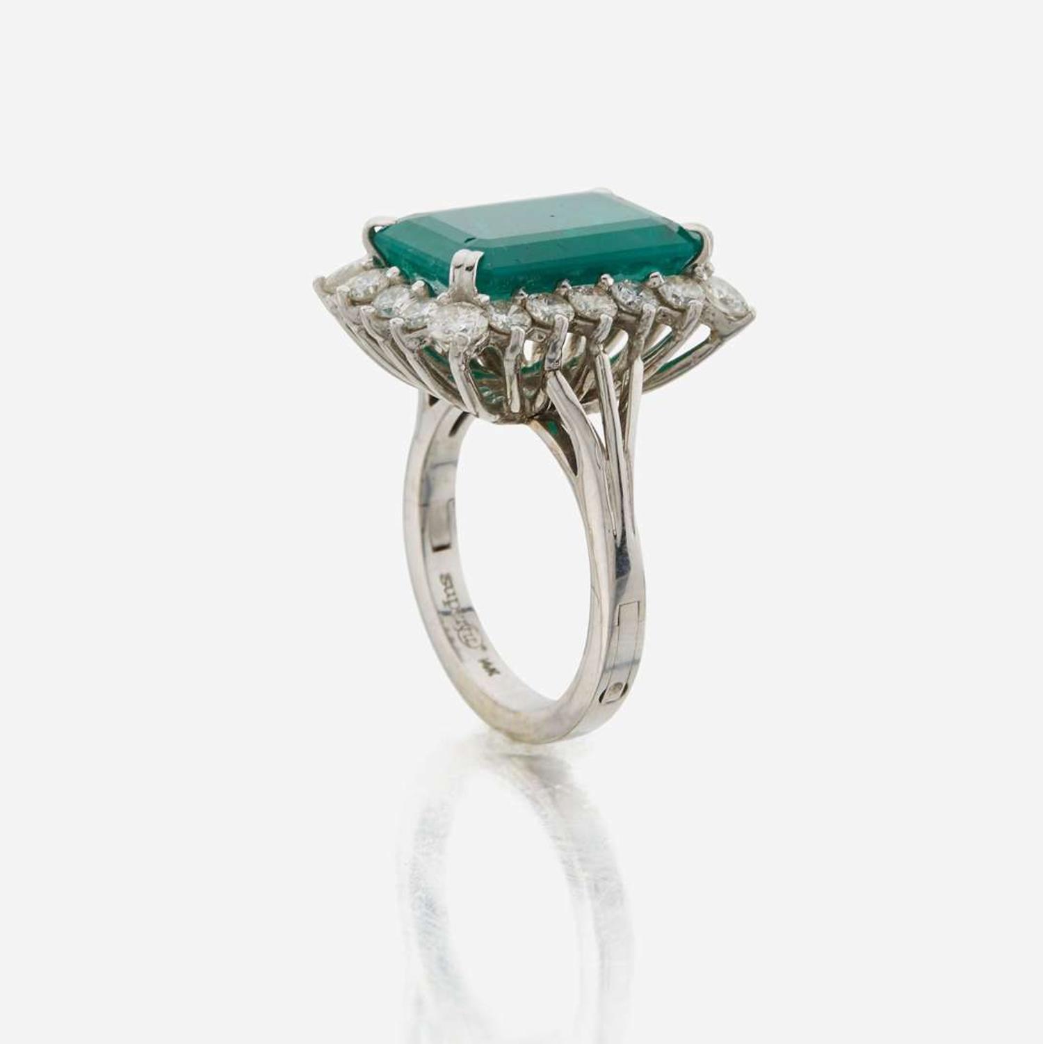 An emerald, diamond, and white gold ring