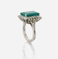 An emerald, diamond, and white gold ring