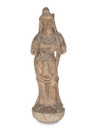 A Chinese Carved Stone Standing Guanyin Figure with Remnants of Polychrome Decoration