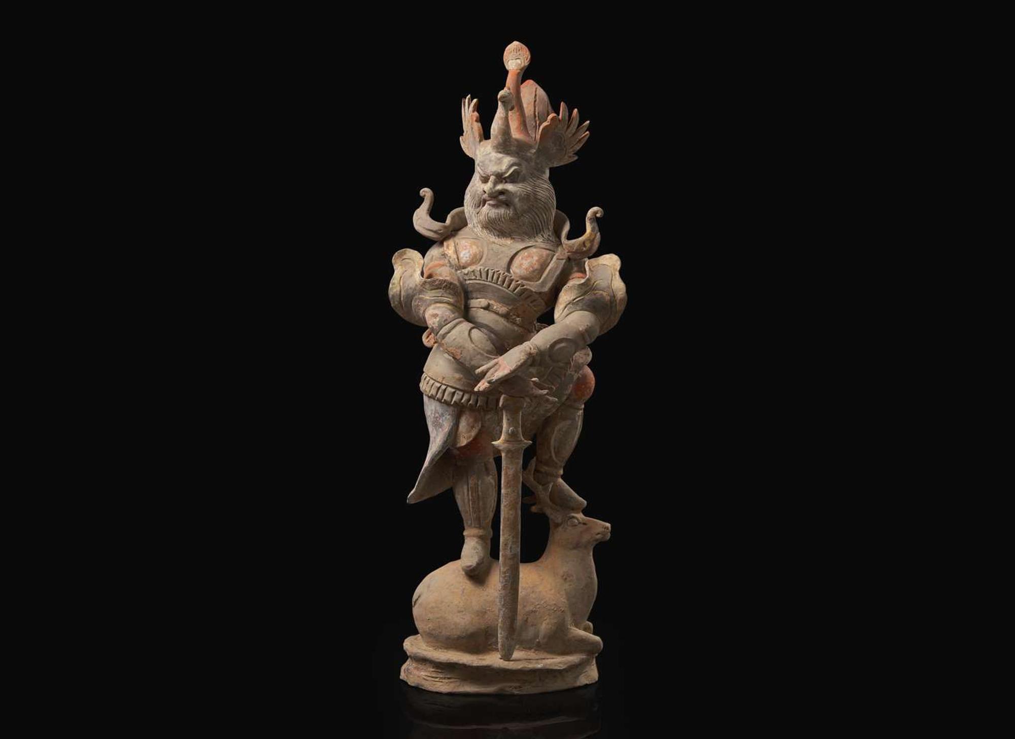 A Chinese painted and parcel-gilt pottery guardian, Tang dynasty 彩繪漆金陶俑天王 唐