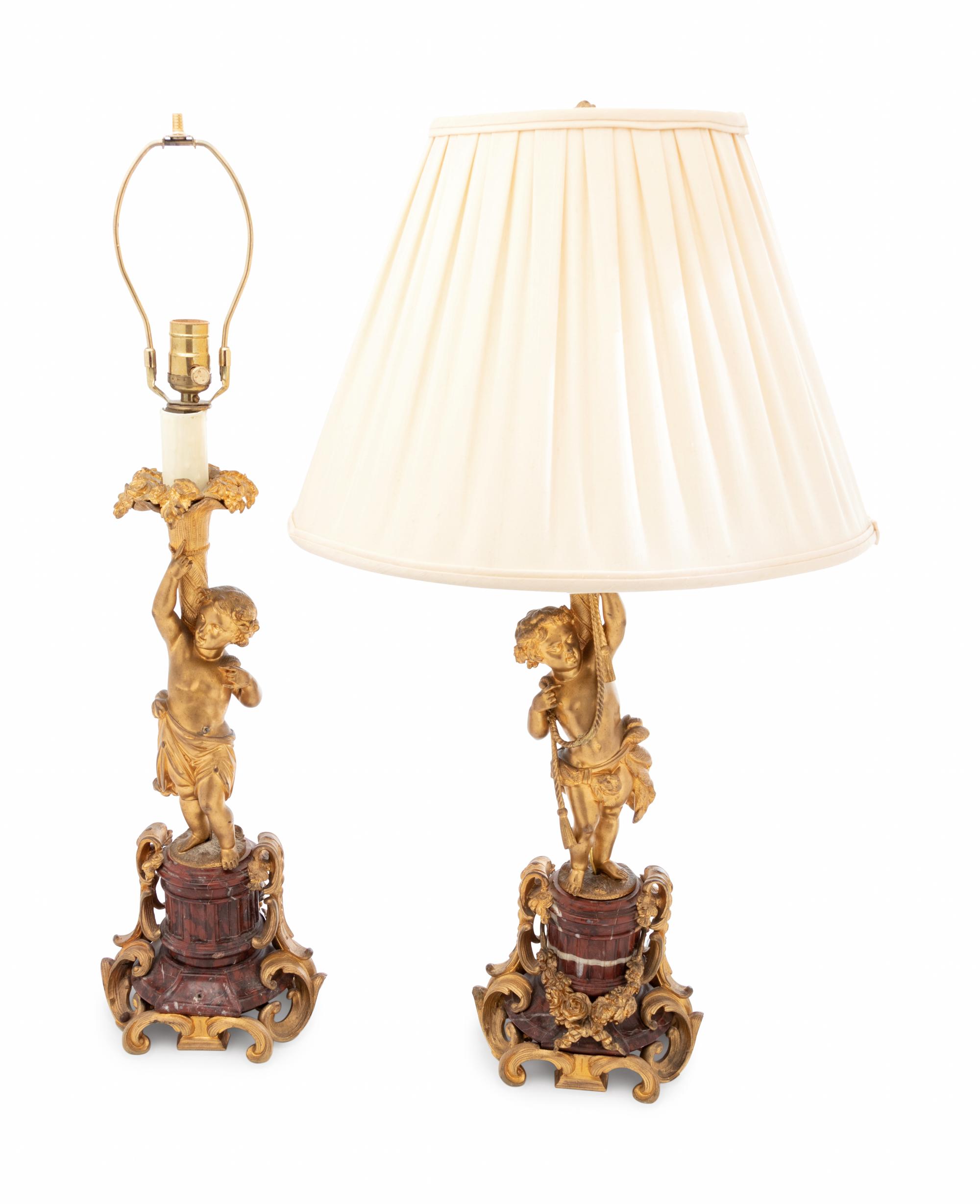 A Pair of Louis XV Style Gilt Bronze Figural Candlesticks